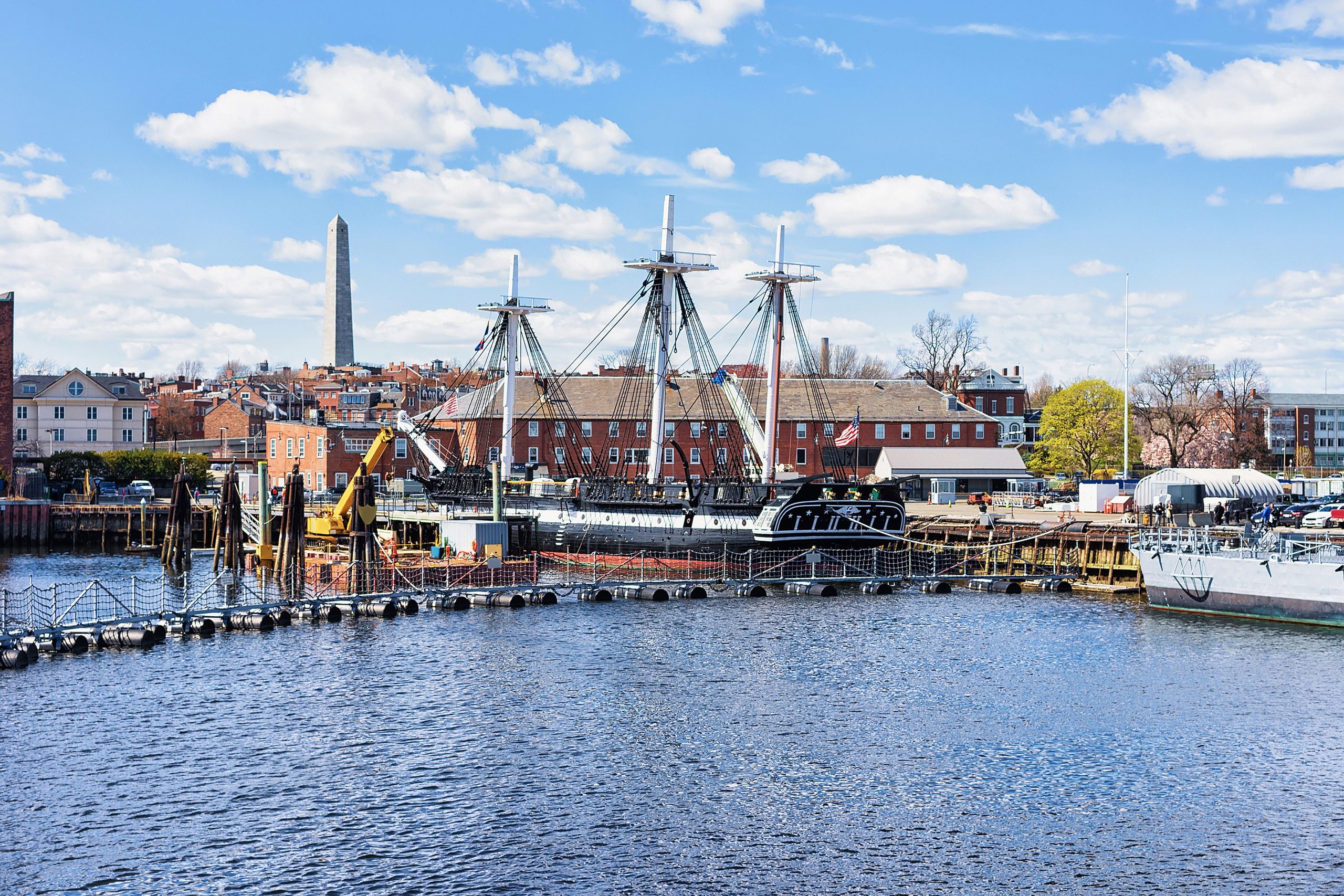 Ship at Charlestown peninsula and Bunher Hill Monument on the background in Boston, MA, the United States.