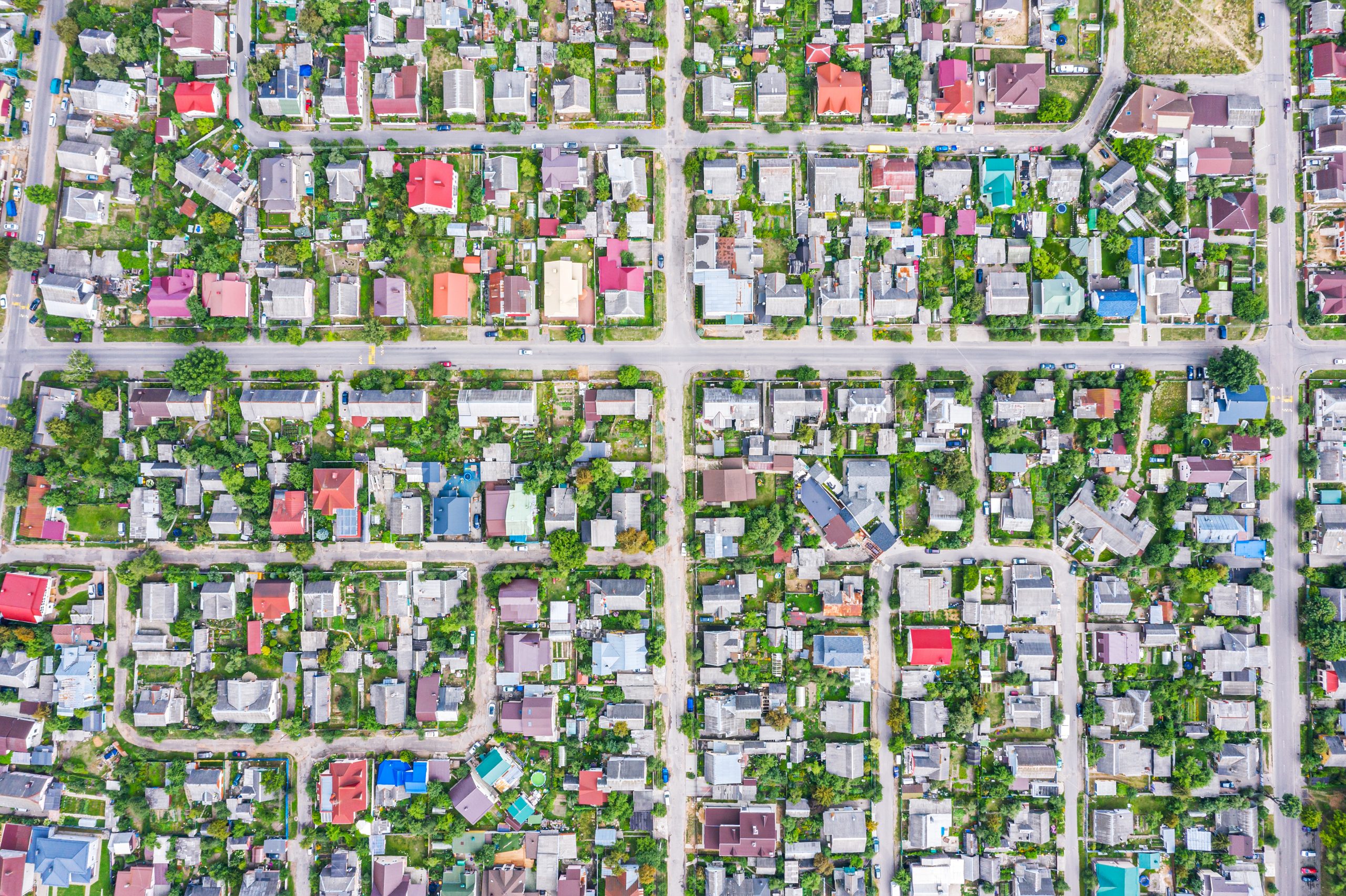 aerial top view of suburb area with houses and asphalt roads. viewpoint from directly above